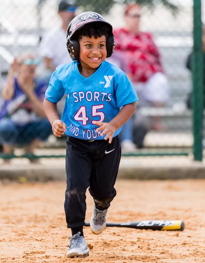 Child playing baseball at the Cibolo Family YMCA Youth Sports Program