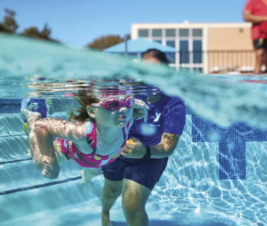 Pre-Schooler learning about swimming strokes at the Y