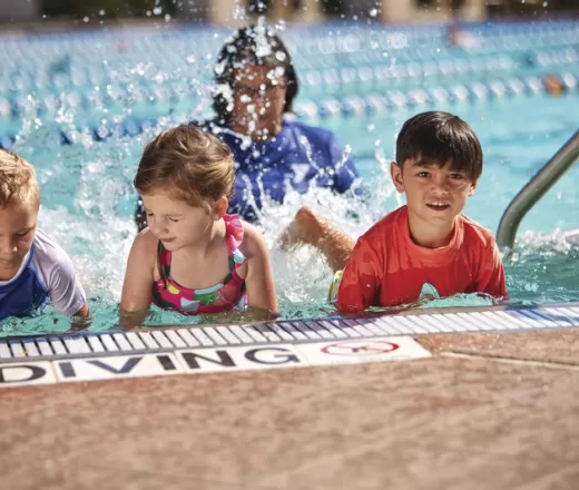 Preschoolers taking a water acclimation swim lesson at the Y