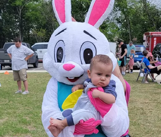 Child being held by the Easter Bunny at a Cibolo Event