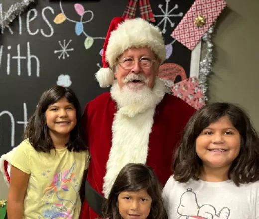 A family visiting Santa Claus during a Christmas event at D.R. Semmes Family YMCA